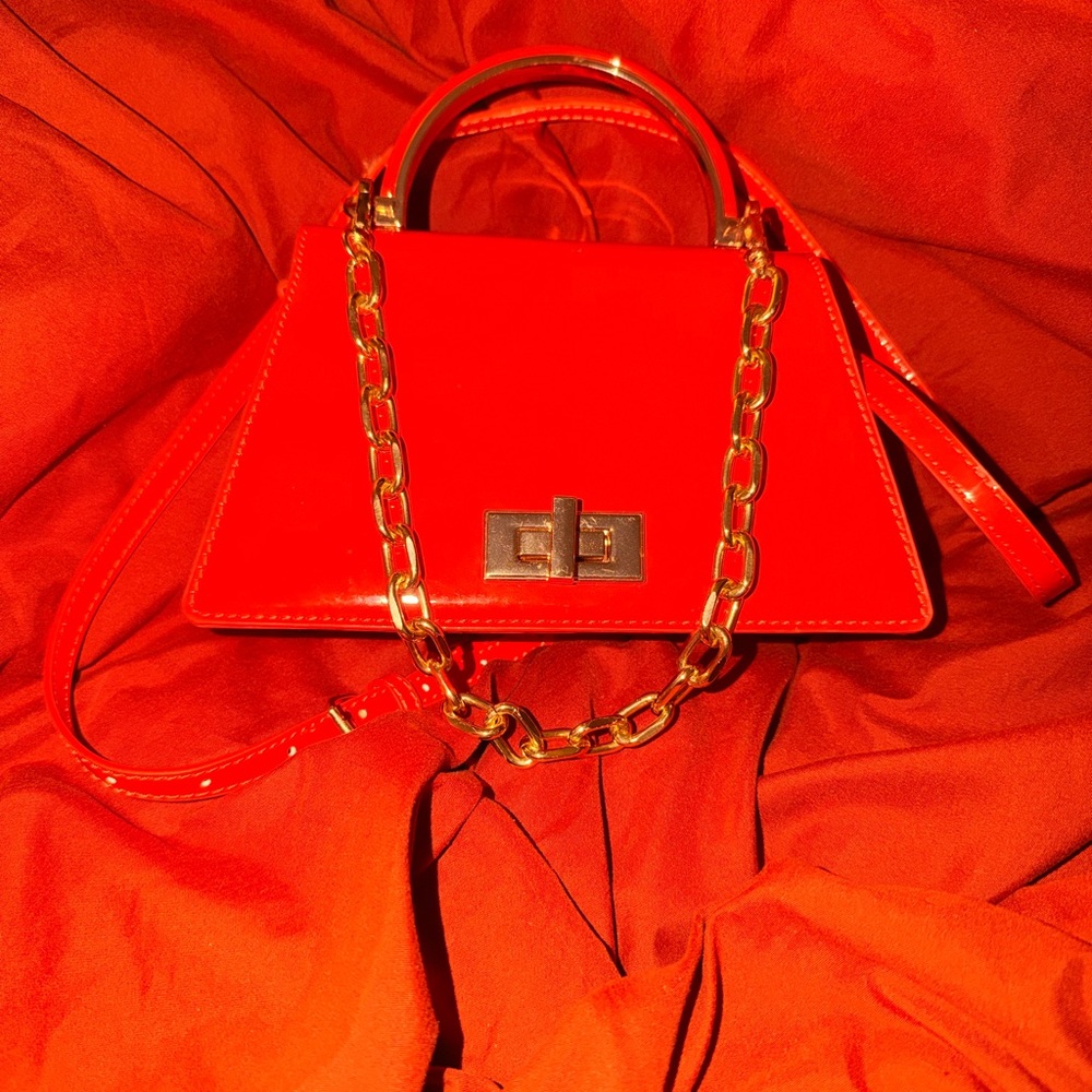 Chic Orange Handbag with Gold Chain